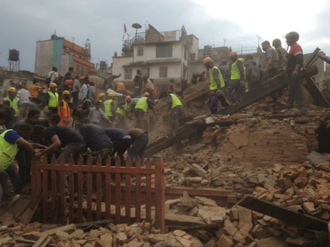 Rescuers clear the debris at Durbar Sqaure after an earthquake in Kathmandu, Nepal, Saturday, April 25, 2015.